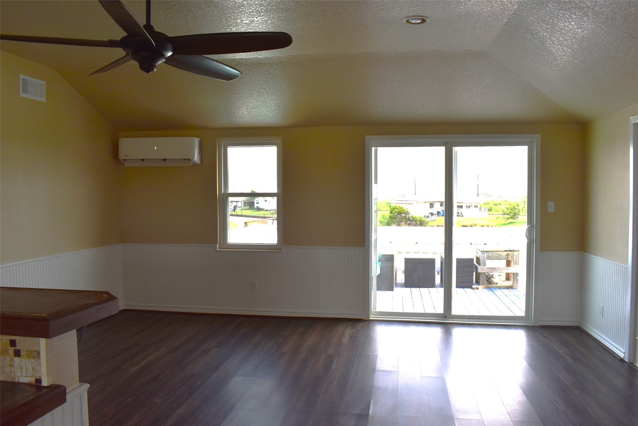 11 Chimaera Street Sargent, TX 77414 - Photo 11 of 40 a view of an empty room with wooden floor and a window