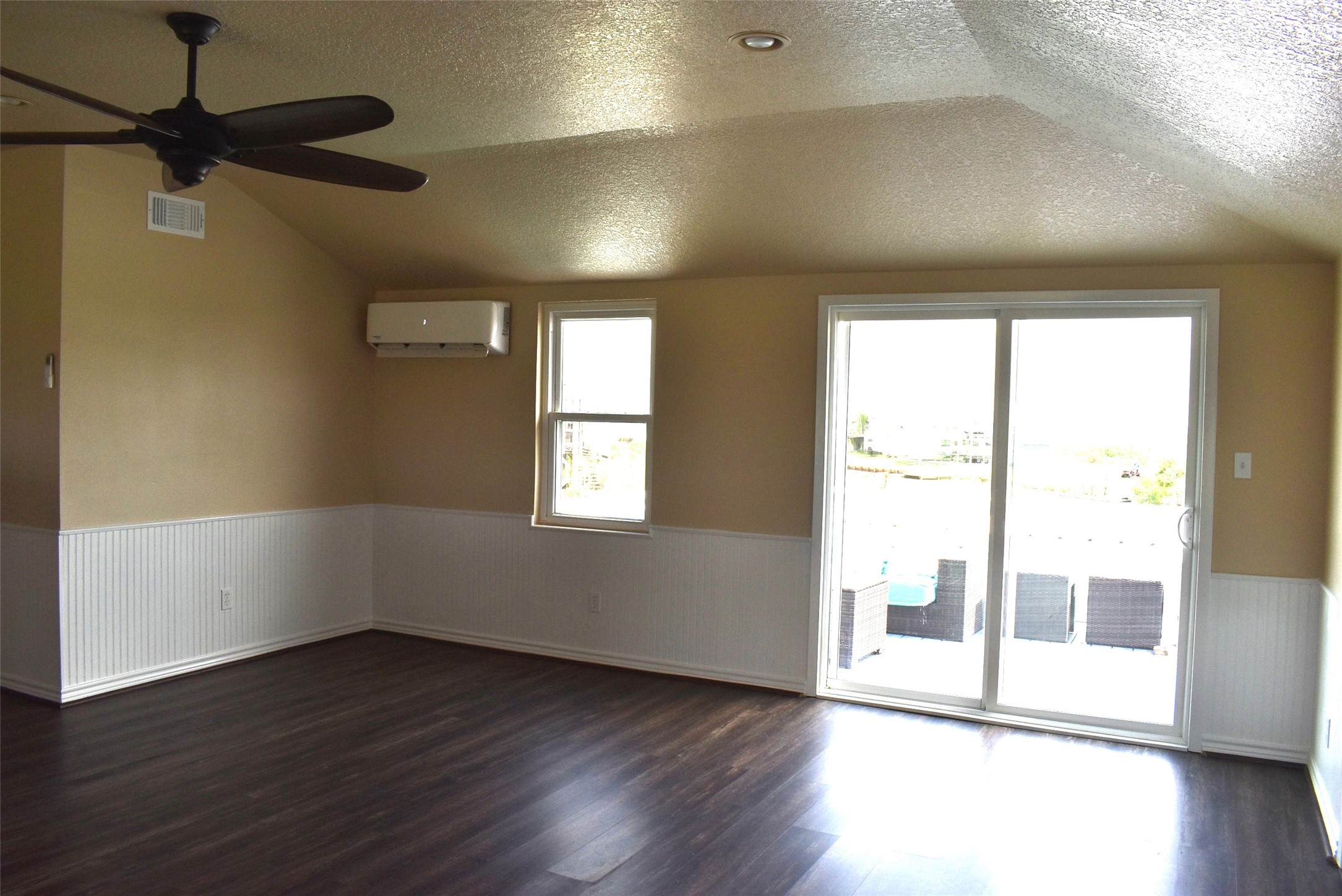 11 Chimaera Street Sargent, TX 77414 - Photo 12 of 40 an empty room with wooden floor and windows
