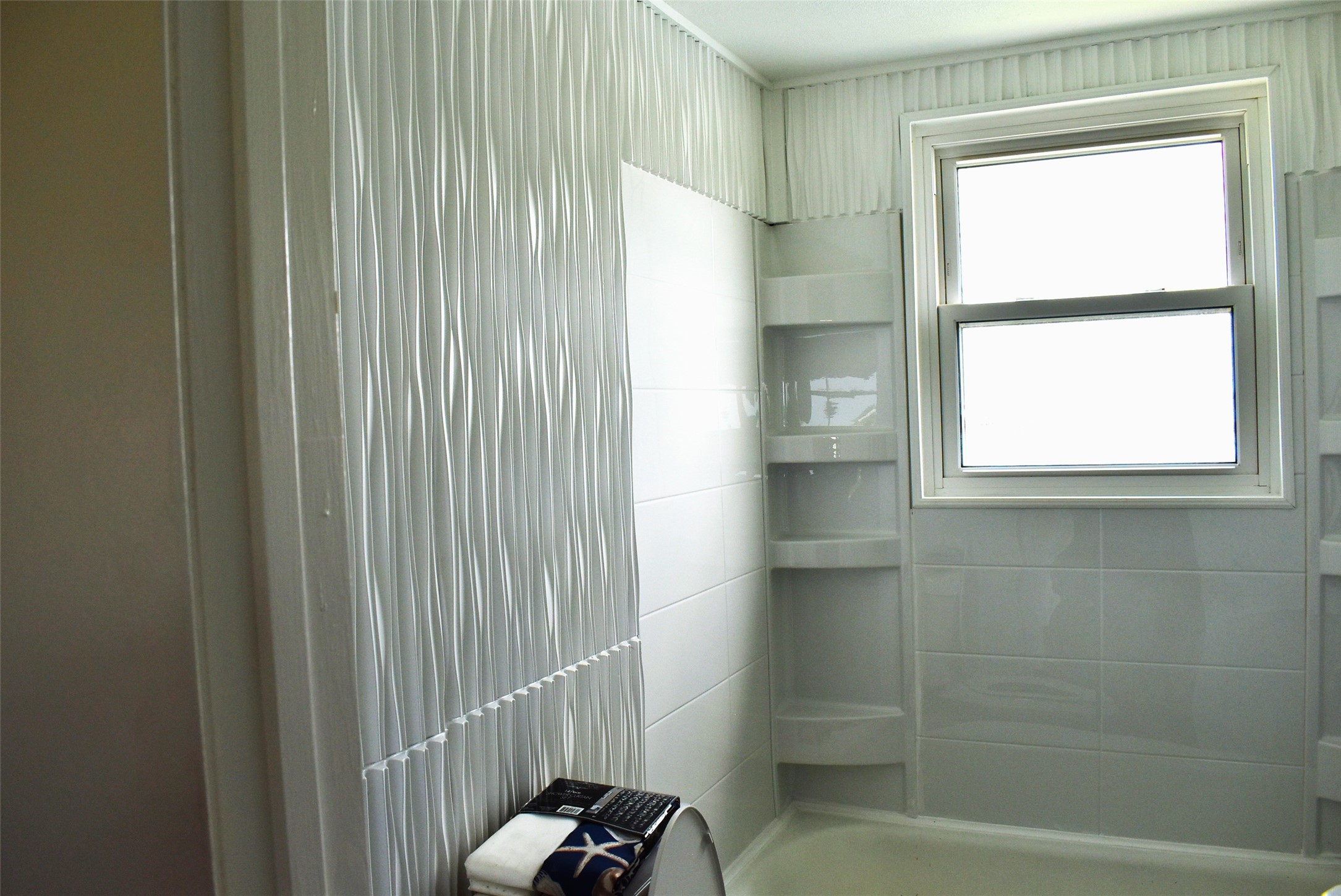 11 Chimaera Street Sargent, TX 77414 - Photo 14 of 40 a bathroom with a window and a shower