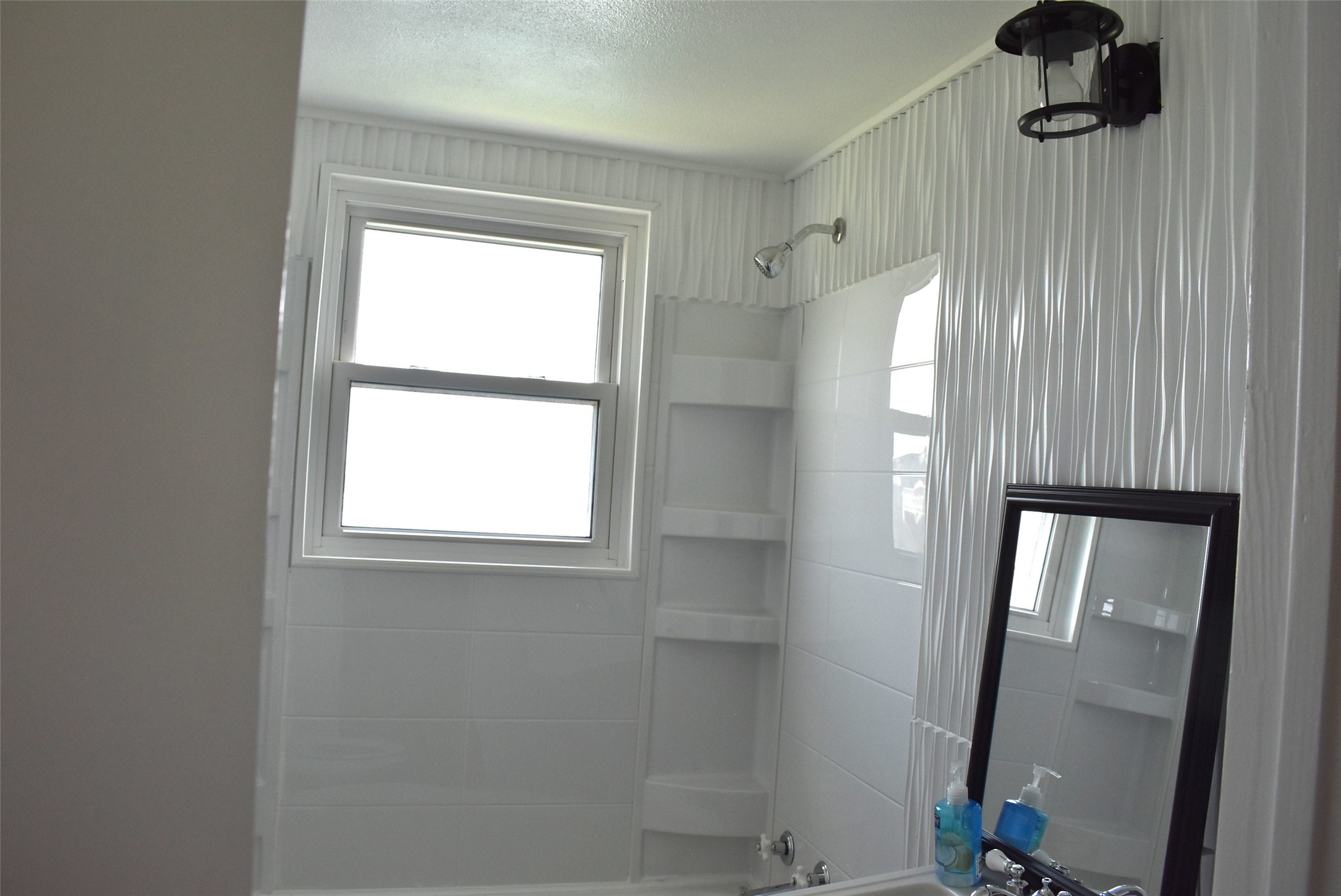 11 Chimaera Street Sargent, TX 77414 - Photo 15 of 40 a bathroom with a shower and a window