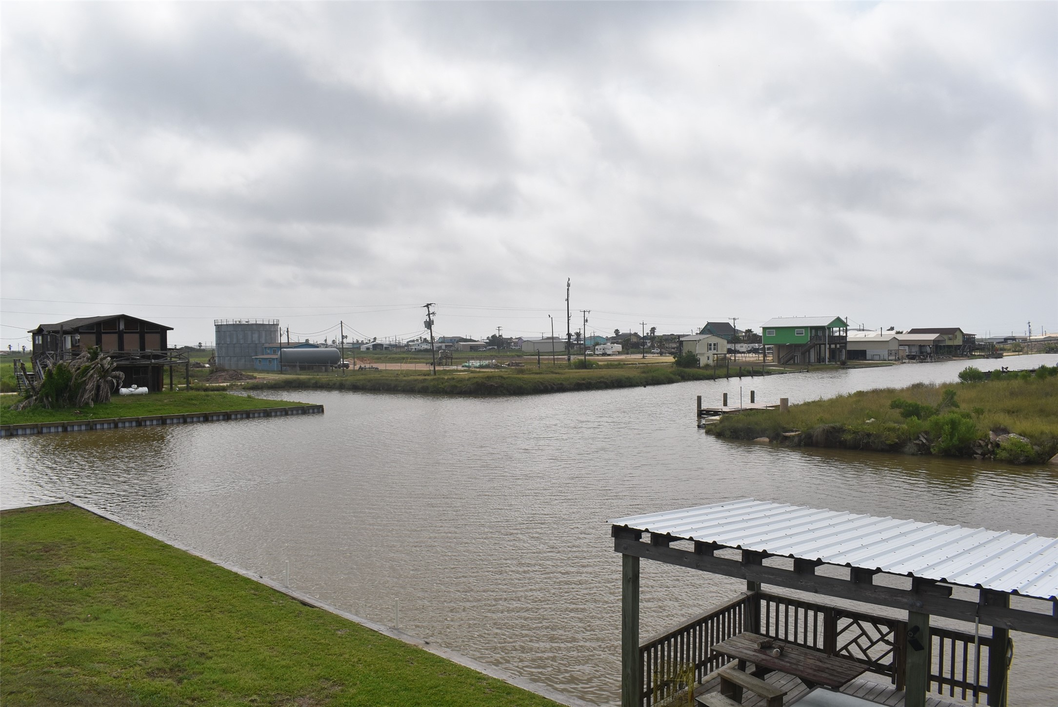 11 Chimaera Street Sargent, TX 77414 - Photo 29 of 40 a view of a lake with table and chairs under an umbrella