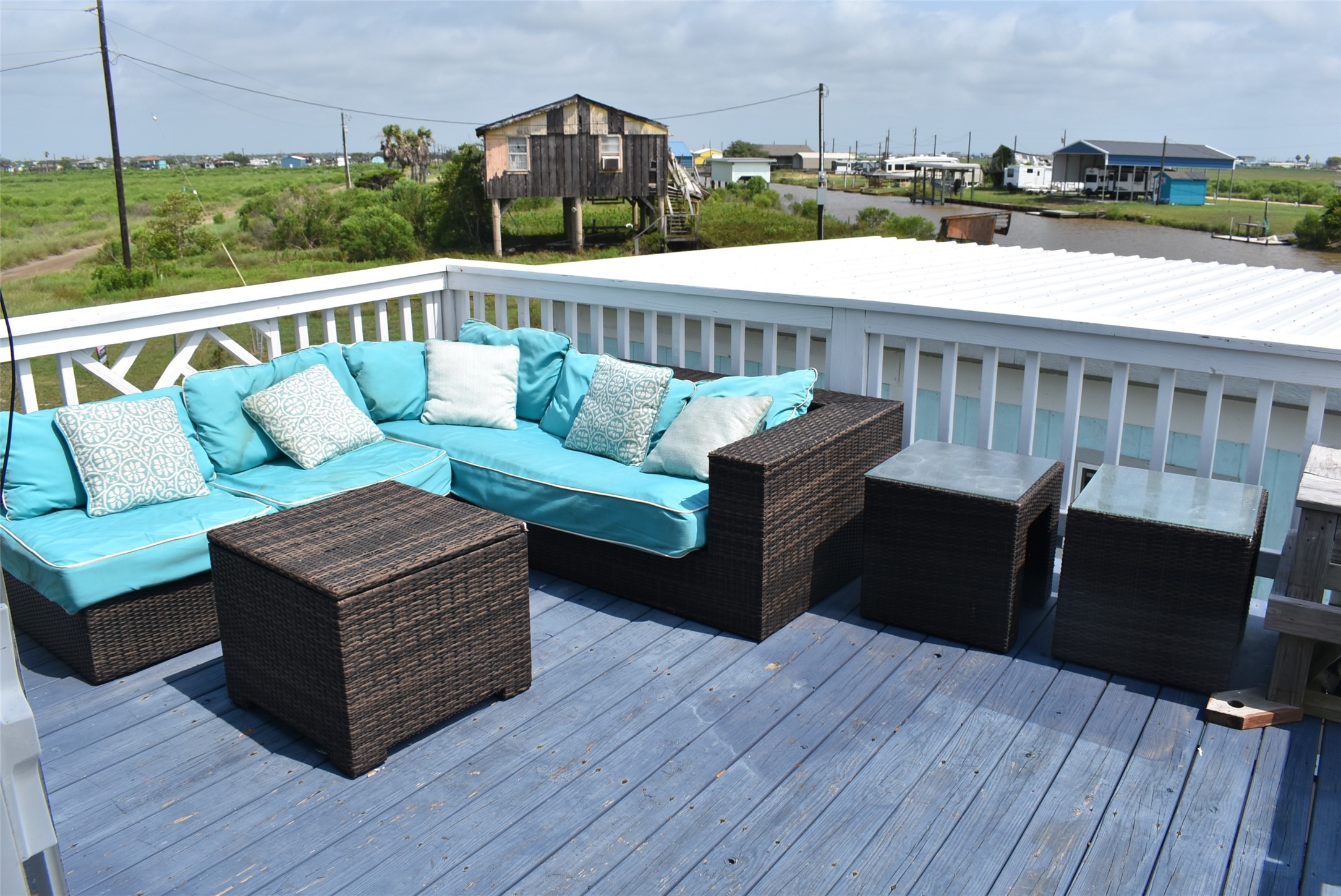 11 Chimaera Street Sargent, TX 77414 - Photo 9 of 40 a roof deck with couches and wooden floor