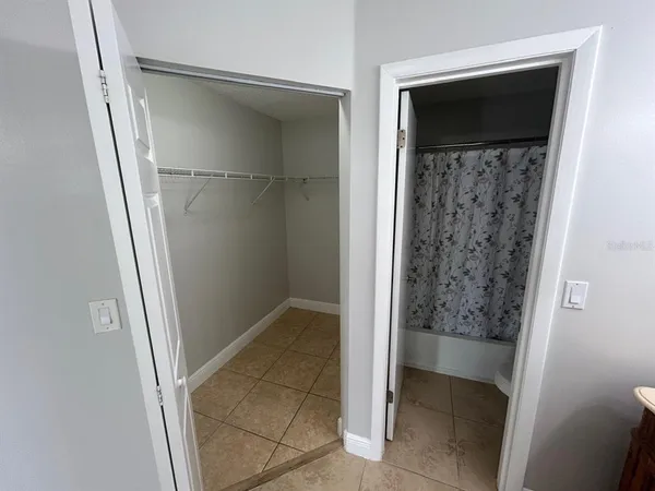 a white toilet sitting next to a shower curtain