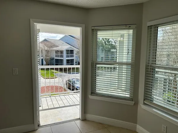 a view of a porch and patio with table and chairs