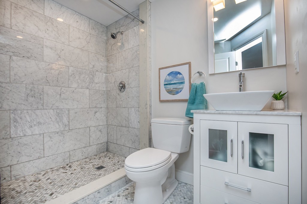 31 Ralph Road Marblehead, MA 01945 - Photo 17 of 24 a bathroom with a toilet sink and shower