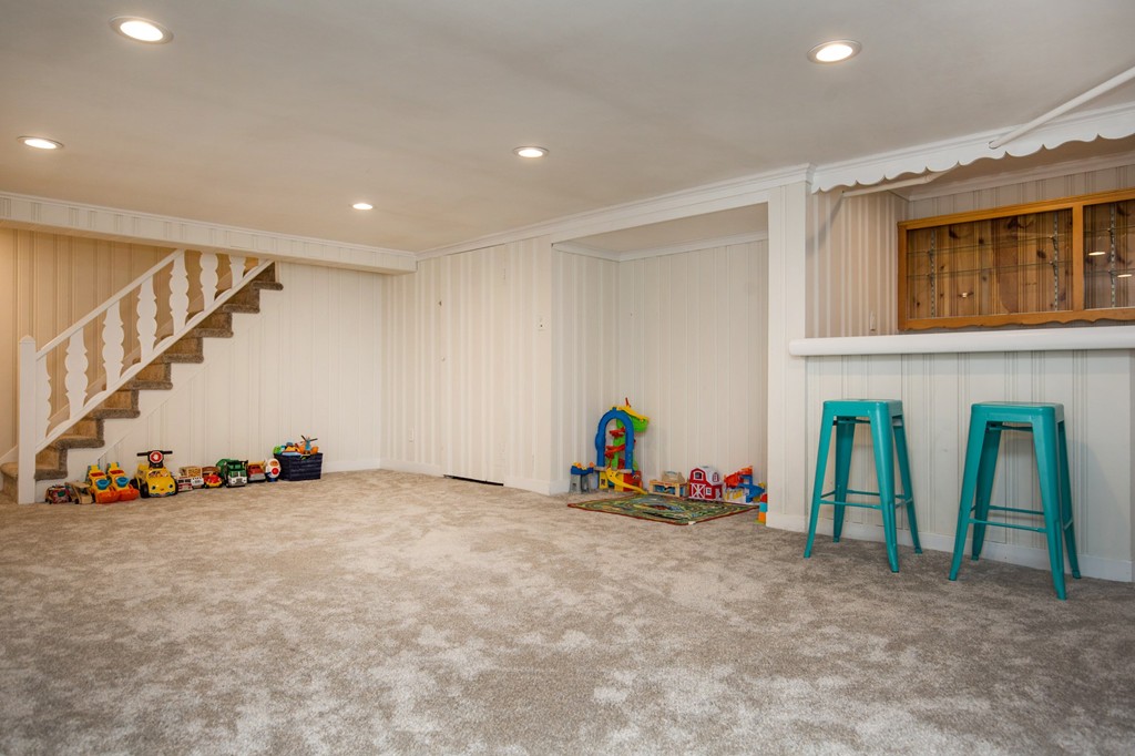 31 Ralph Road Marblehead, MA 01945 - Photo 22 of 24 a view of an empty room with stairs and toys
