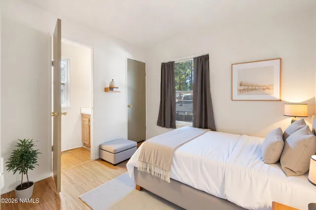 a bedroom with a bed and a potted plant
