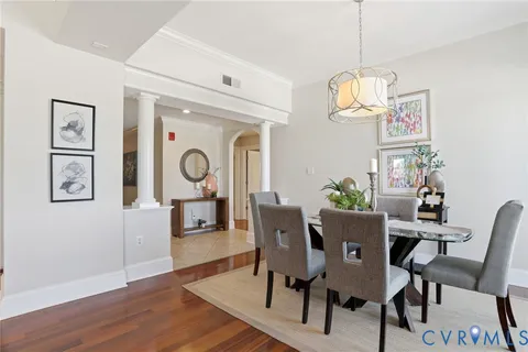a view of a dining room with furniture wooden floor and chandelier