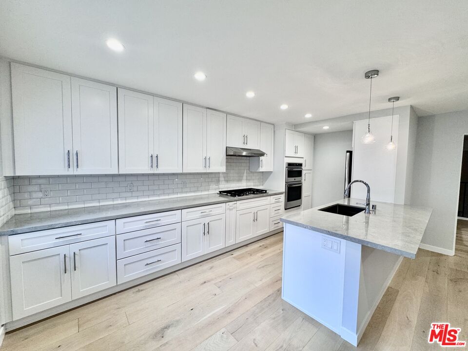 4435 Alla Road, Unit 4 Marina del Rey, CA 90292 - Photo 1 of 23 a kitchen with white cabinets appliances and sink