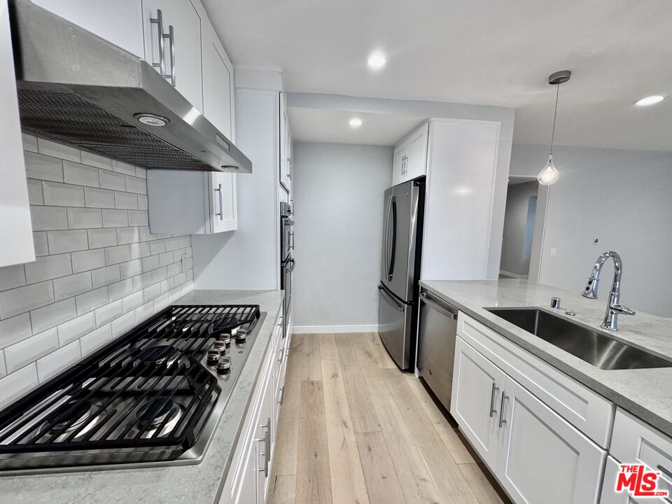 4435 Alla Road, Unit 4 Marina del Rey, CA 90292 - Photo 11 of 23 a kitchen with granite countertop a stove and a sink