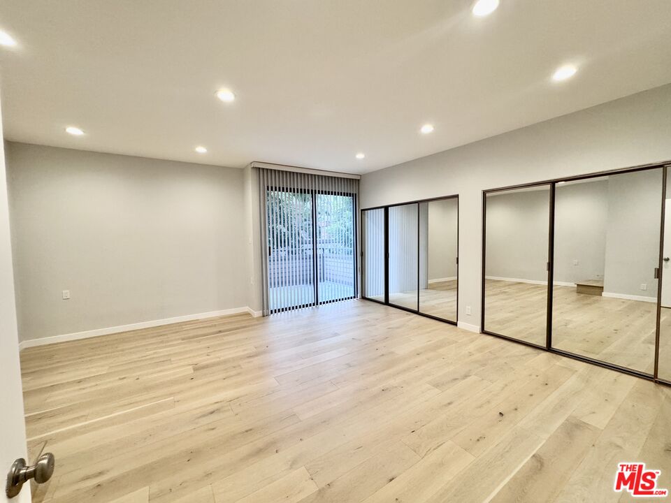4435 Alla Road, Unit 4 Marina del Rey, CA 90292 - Photo 15 of 23 an empty room with wooden floor and sliding door