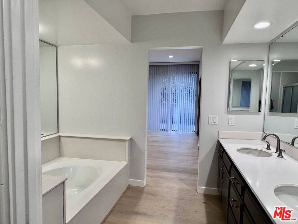 4435 Alla Road, Unit 4 Marina del Rey, CA 90292 - Photo 17 of 23 a bathroom with a tub sink and mirror
