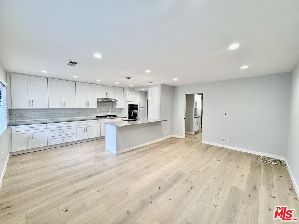 4435 Alla Road, Unit 4 Marina del Rey, CA 90292 - Photo 8 of 23 a large kitchen with stainless steel appliances kitchen island a large counter top and a stove top oven