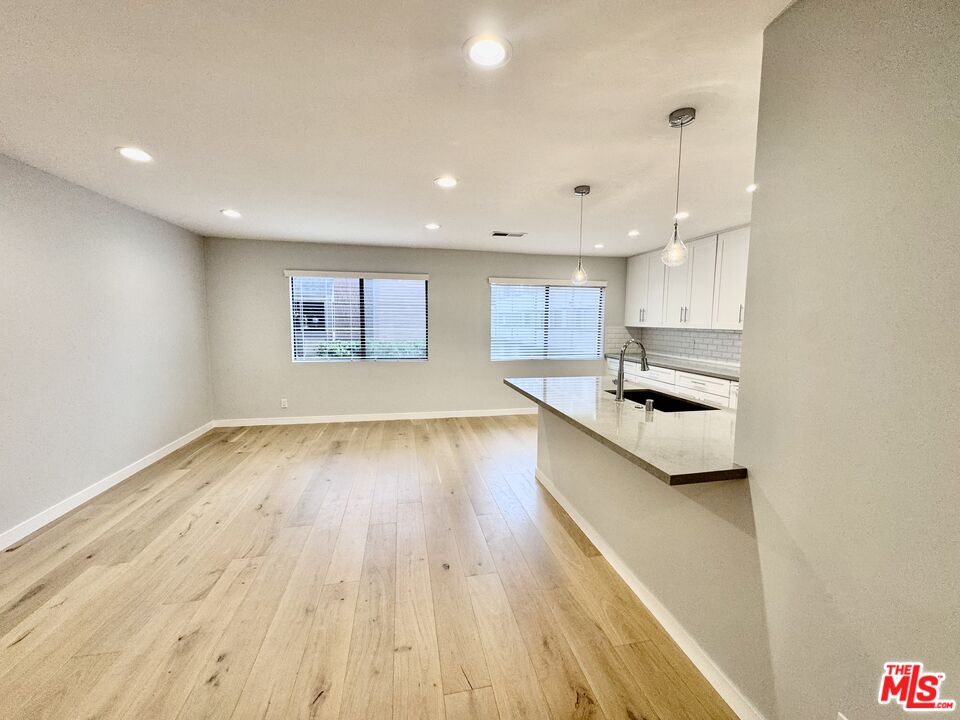 4435 Alla Road, Unit 4 Marina del Rey, CA 90292 - Photo 9 of 23 a large kitchen with a wooden floor and stainless steel appliances