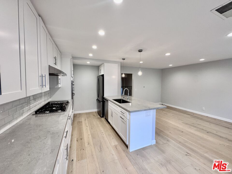 4435 Alla Road, Unit 4 Marina del Rey, CA 90292 - Photo 10 of 23 a large kitchen with stainless steel appliances a large counter top a stove and a refrigerator