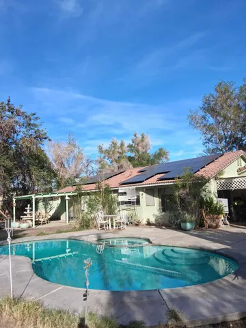 a view of a swimming pool with a patio