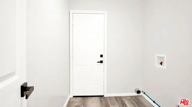 a view of a room with wooden floor and windows