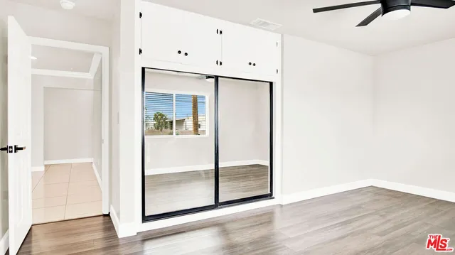 a view of a room with wooden floor
