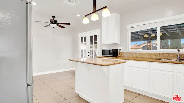 a kitchen with stove and cabinets
