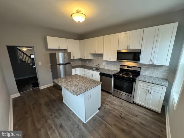 a kitchen with a stove a refrigerator and a sink