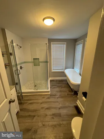a bathroom with a toilet and a shower