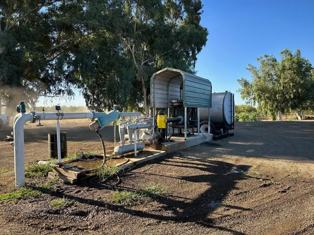 a view of a roof deck with table and chairs a fire pit and a large tree