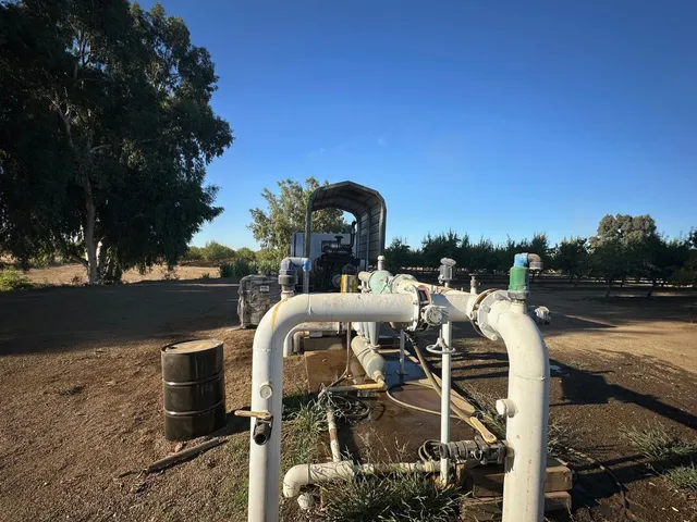 a view of a swimming pool with a chairs and table in the patio