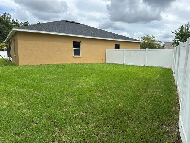 a front view of house with yard and garage
