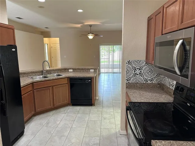 a kitchen with a sink stove and refrigerator