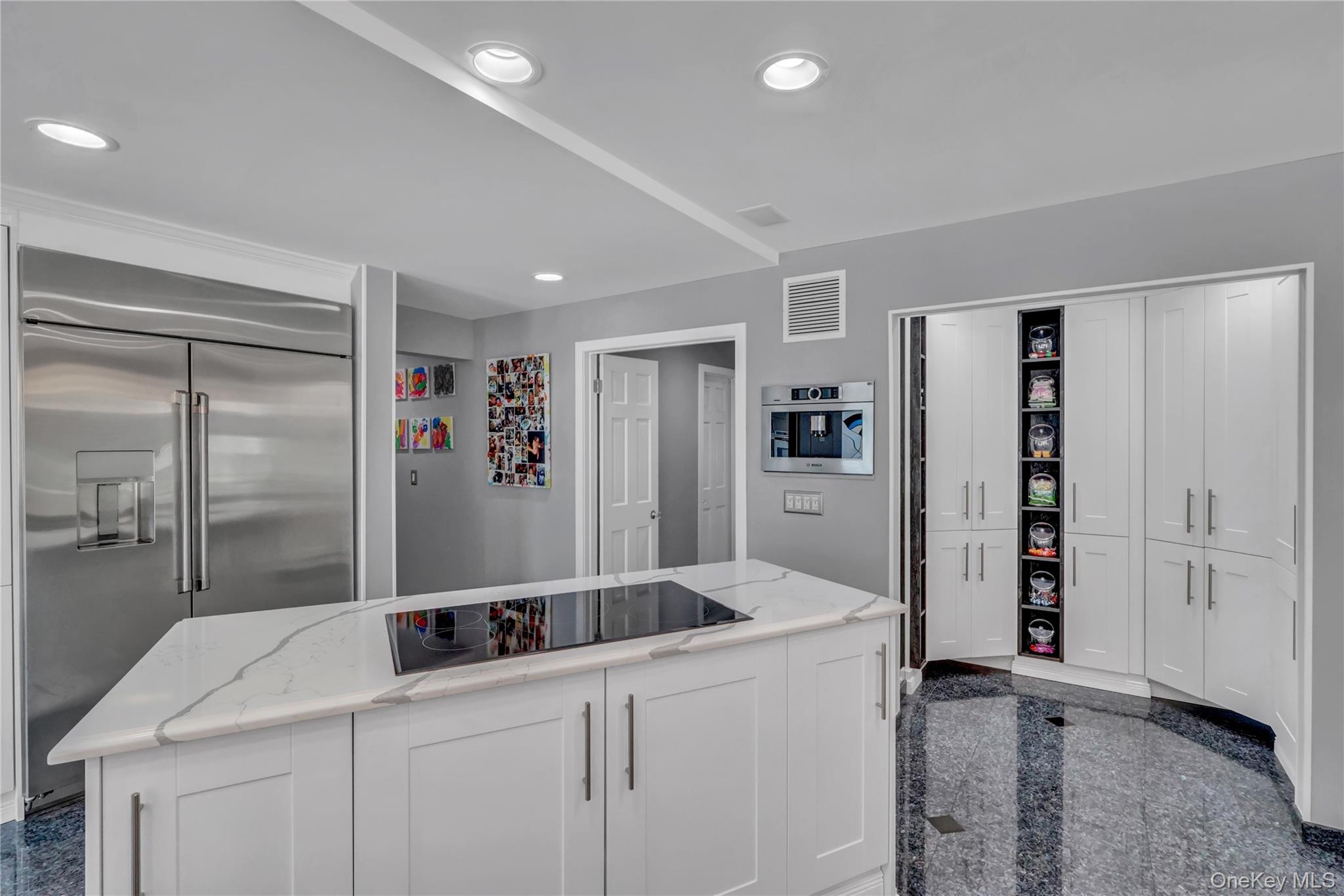 83 Cliff Road Port Jefferson, NY 11777 - Photo 13 of 50 Kitchen featuring granite floors, built in fridge, white cabinetry, recessed lighting, and black electric cooktop