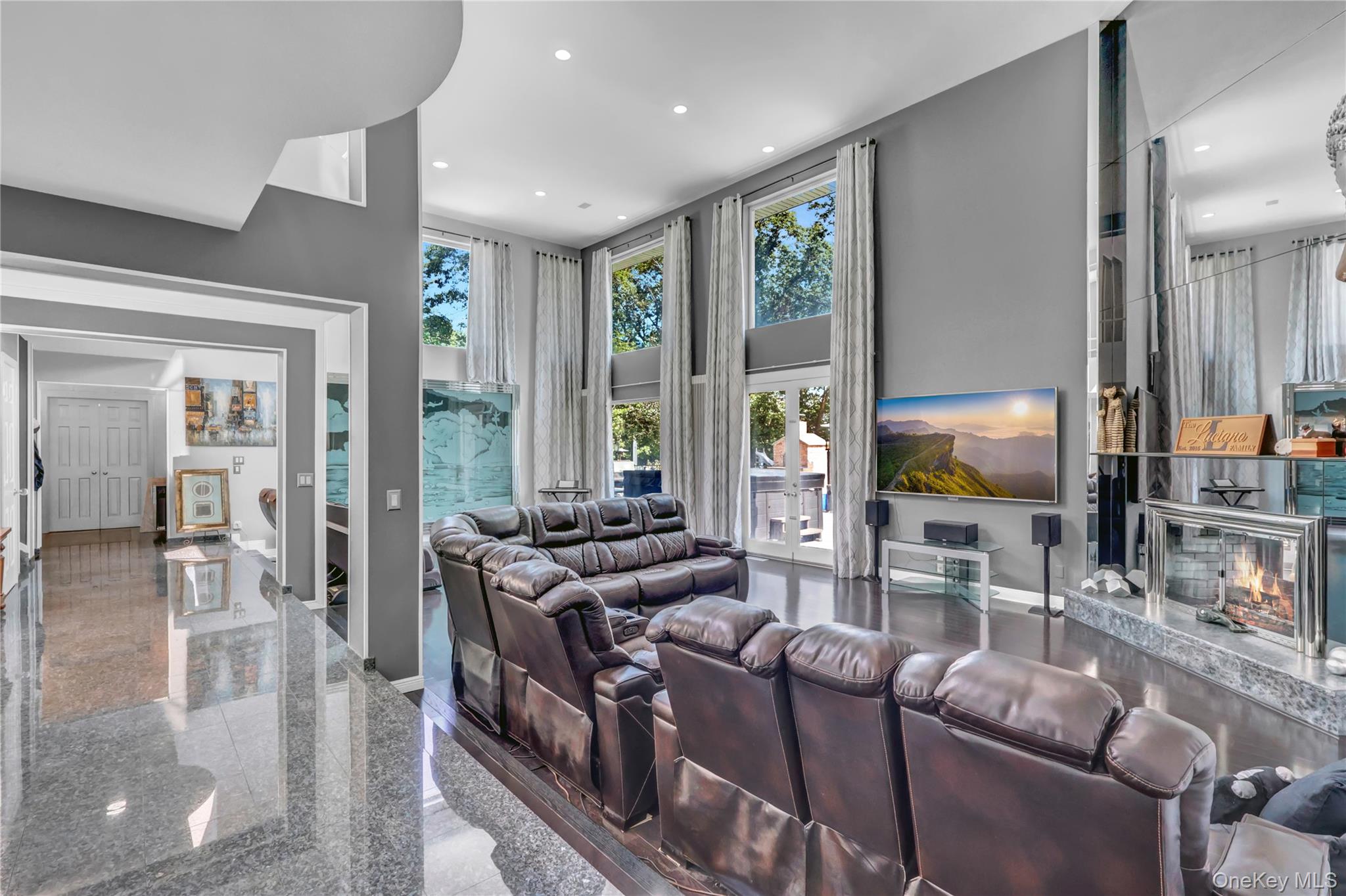 83 Cliff Road Port Jefferson, NY 11777 - Photo 15 of 50 Living room with granite tiled floors, a towering ceiling, a fireplace, and recessed lighting