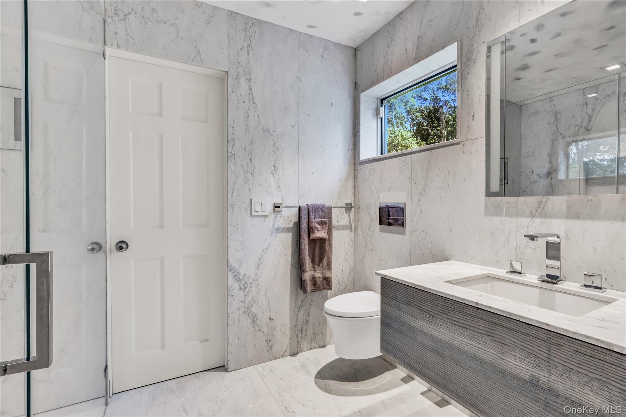 83 Cliff Road Port Jefferson, NY 11777 - Photo 20 of 50 Bathroom featuring vanity and a marble finish shower