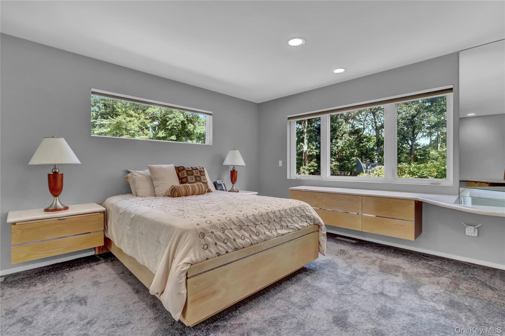83 Cliff Road Port Jefferson, NY 11777 - Photo 24 of 50 Bedroom featuring multiple windows, light colored carpet, and recessed lighting