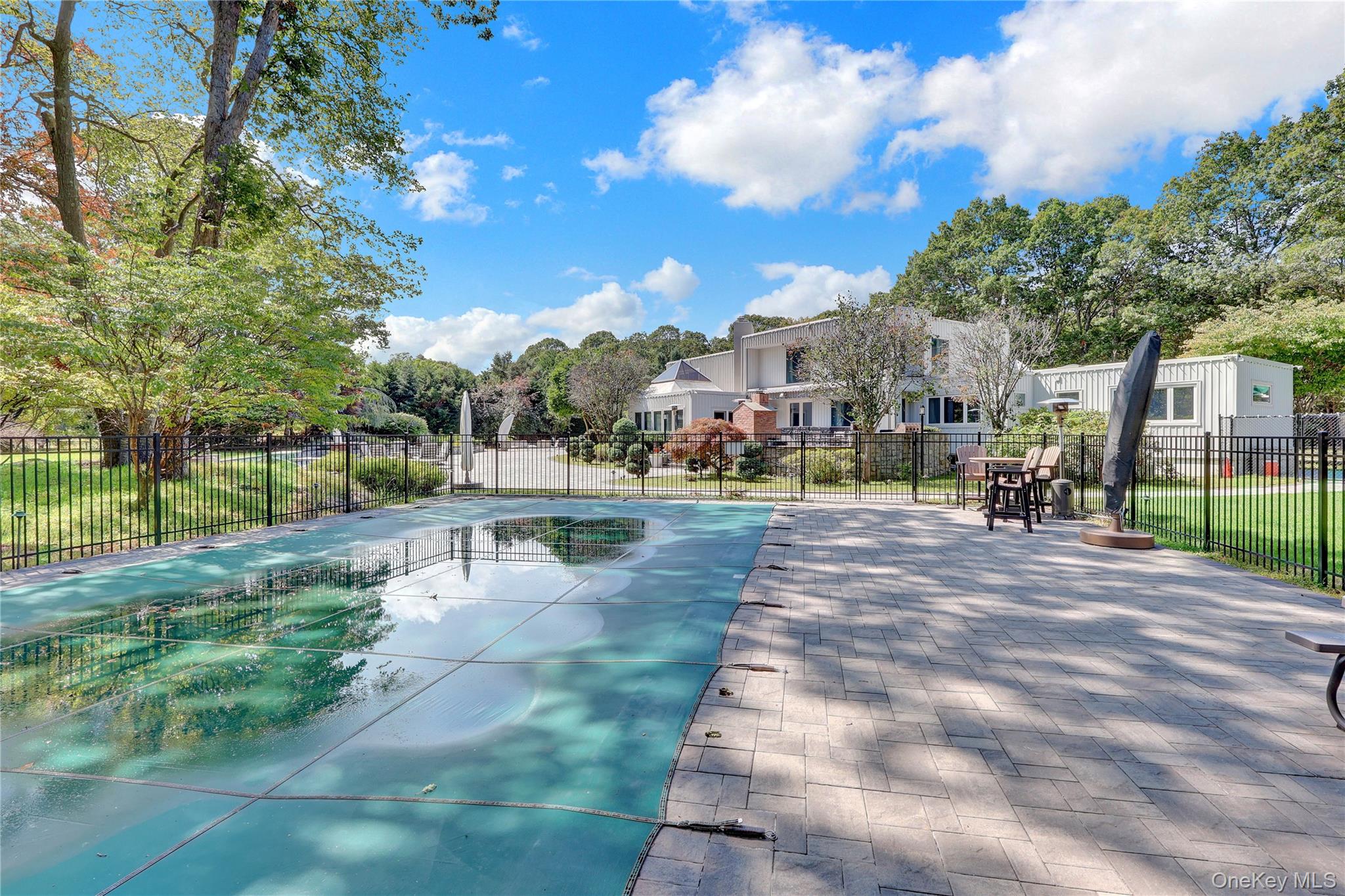 83 Cliff Road Port Jefferson, NY 11777 - Photo 41 of 50 View of pool with a patio and view of wooded area