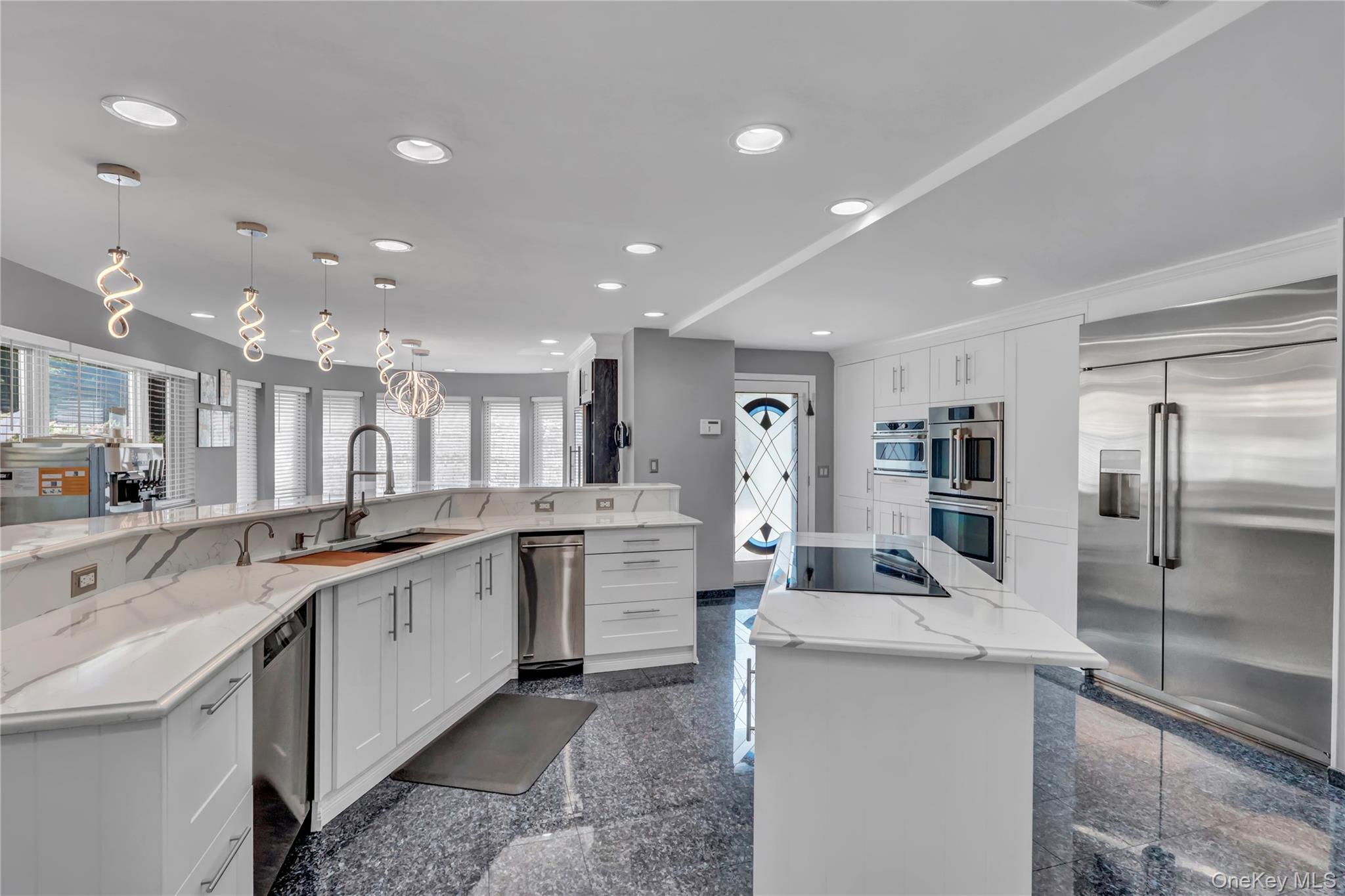 83 Cliff Road Port Jefferson, NY 11777 - Photo 6 of 50 Kitchen with granite floors, stainless steel appliances, white cabinets, light stone counters, and pendant lighting