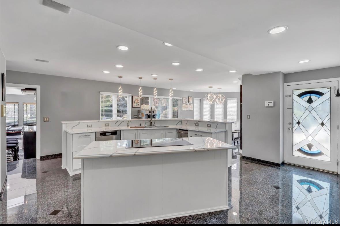 83 Cliff Road Port Jefferson, NY 11777 - Photo 8 of 50 Kitchen featuring granite floors, white cabinetry, recessed lighting, light stone counters, and decorative light fixtures