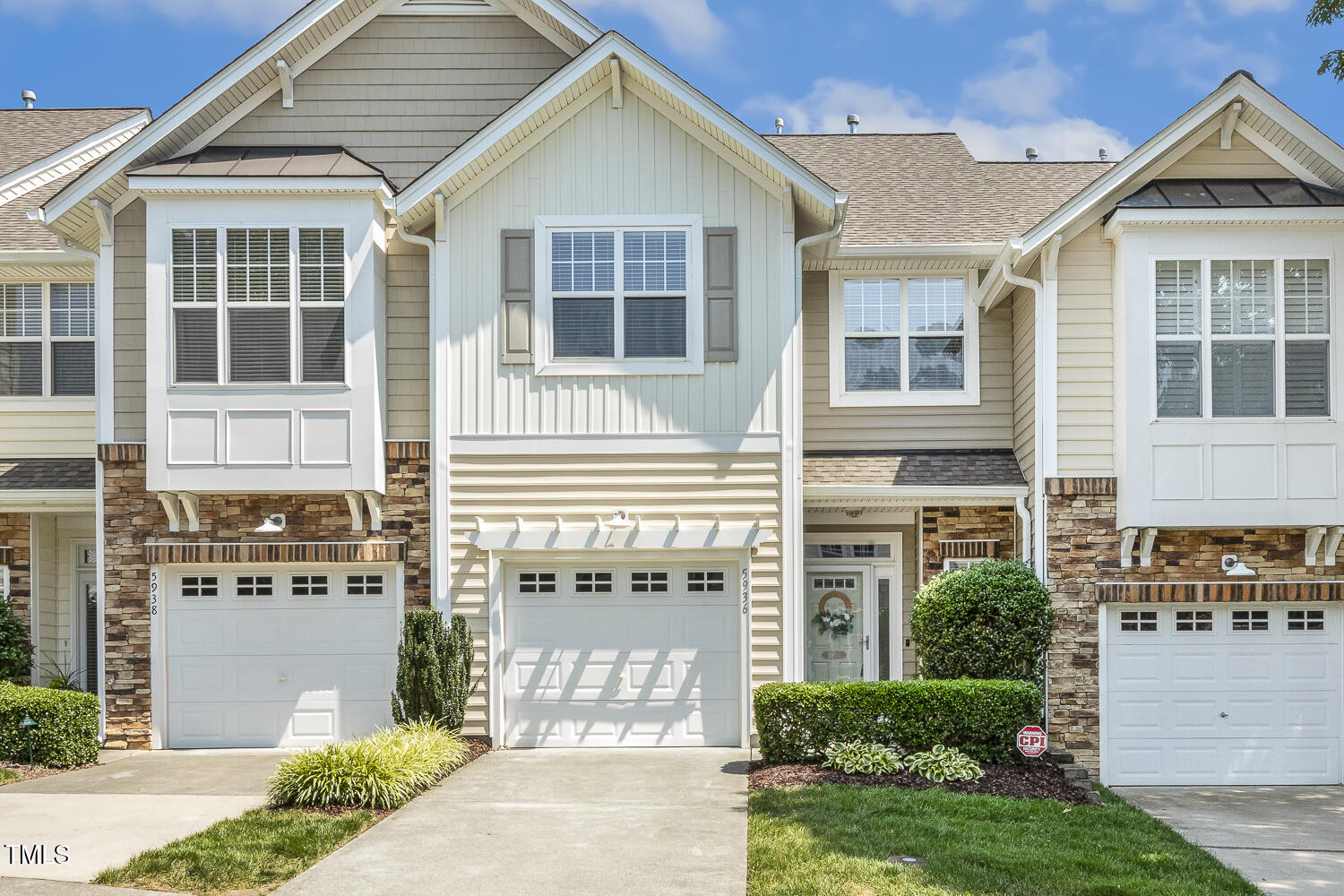 5936 Hourglass Court Raleigh, NC 27612 - Photo 1 of 15 a front view of a house with a yard and garage