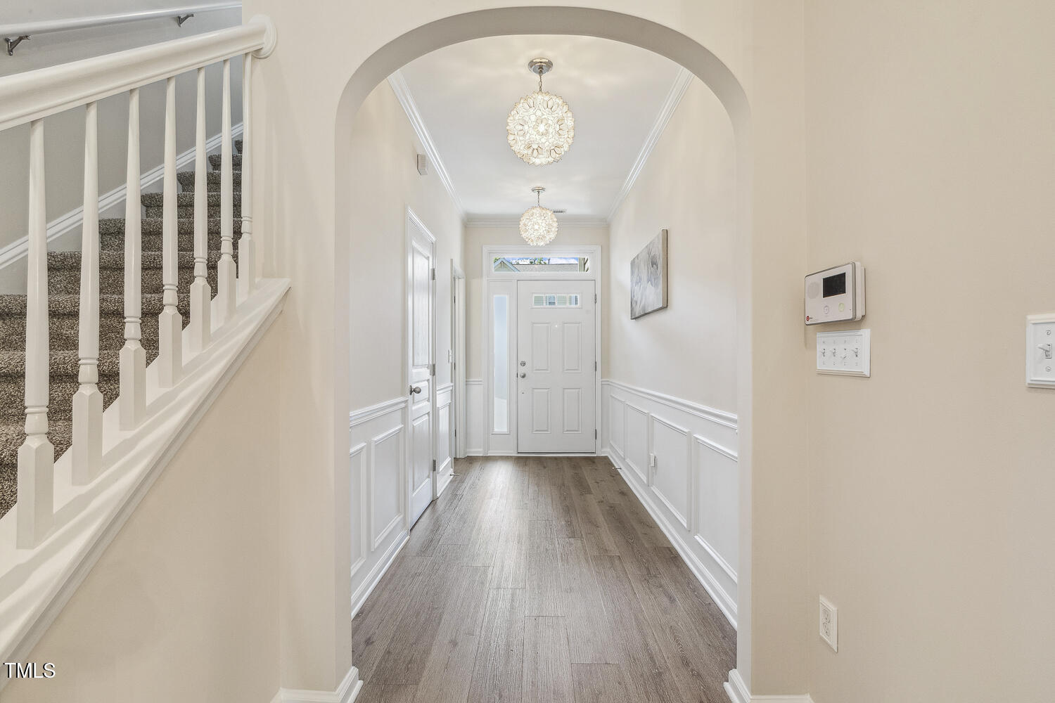 5936 Hourglass Court Raleigh, NC 27612 - Photo 2 of 15 a view of a hallway with wooden floor