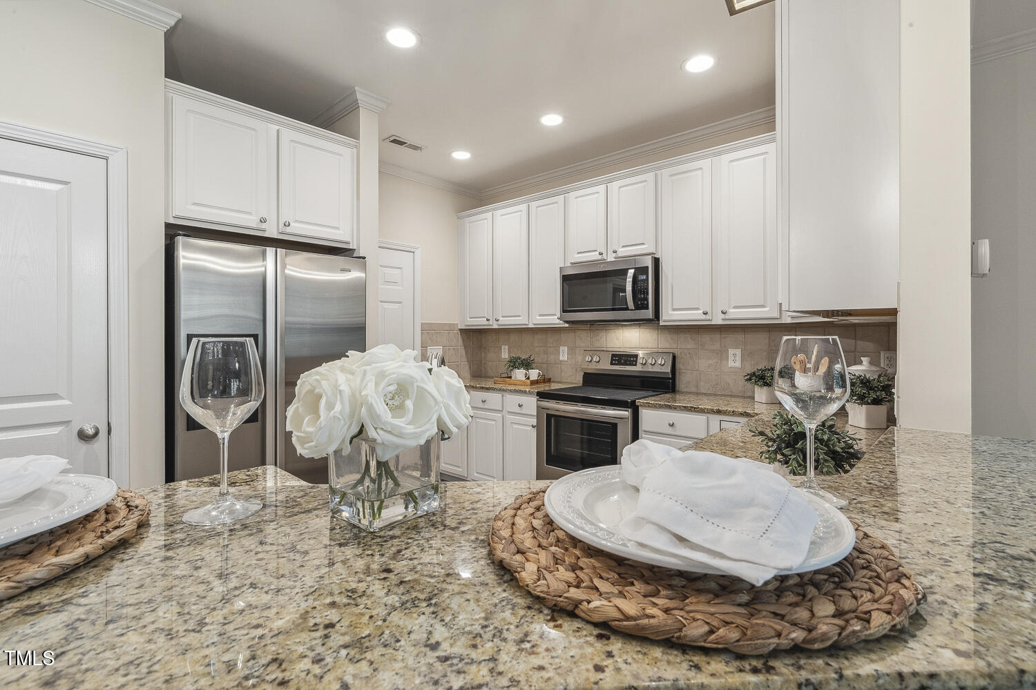 5936 Hourglass Court Raleigh, NC 27612 - Photo 3 of 15 a kitchen with a sink a stove and a refrigerator