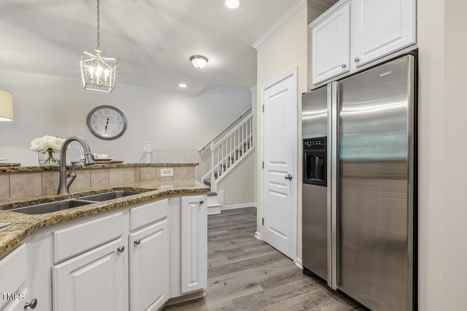 5936 Hourglass Court Raleigh, NC 27612 - Photo 4 of 15 a kitchen with stainless steel appliances granite countertop a sink and a refrigerator