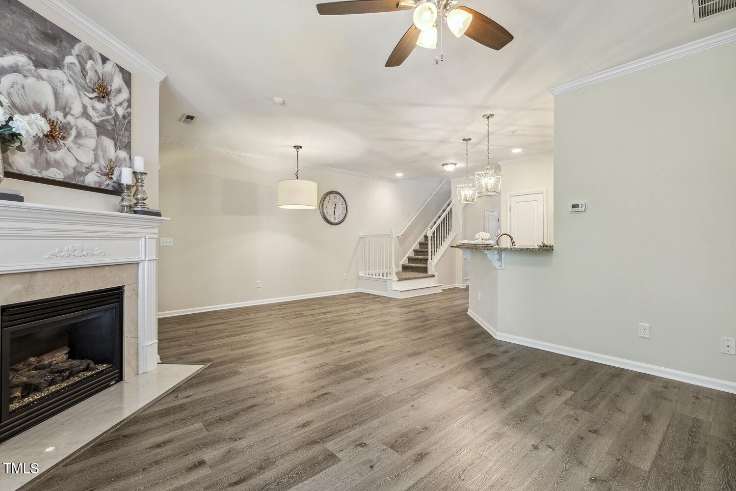 5936 Hourglass Court Raleigh, NC 27612 - Photo 6 of 15 an empty room with wooden floor a fire place and a fireplace