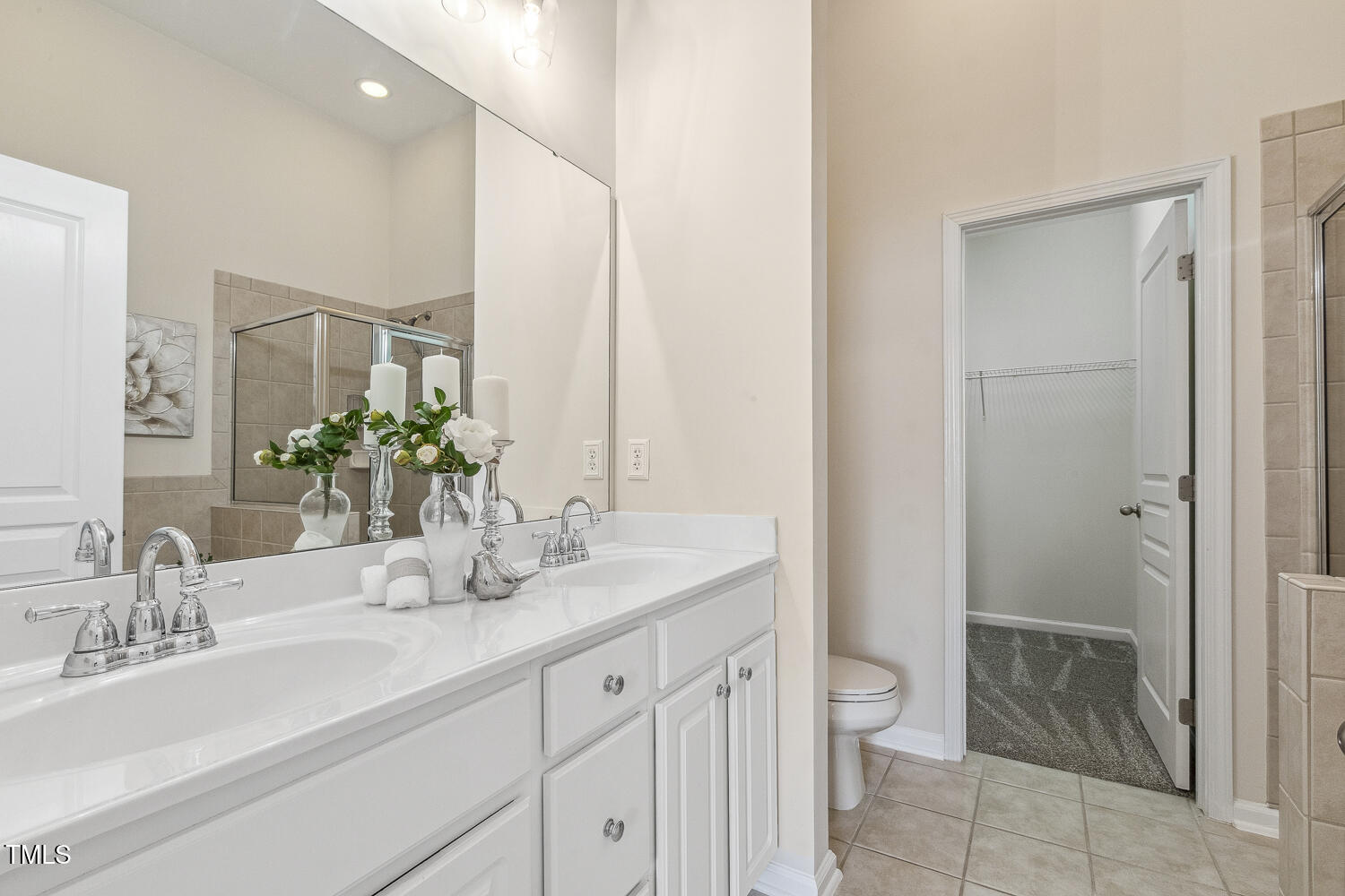 5936 Hourglass Court Raleigh, NC 27612 - Photo 9 of 15 a bathroom with a granite countertop sink a toilet and shower