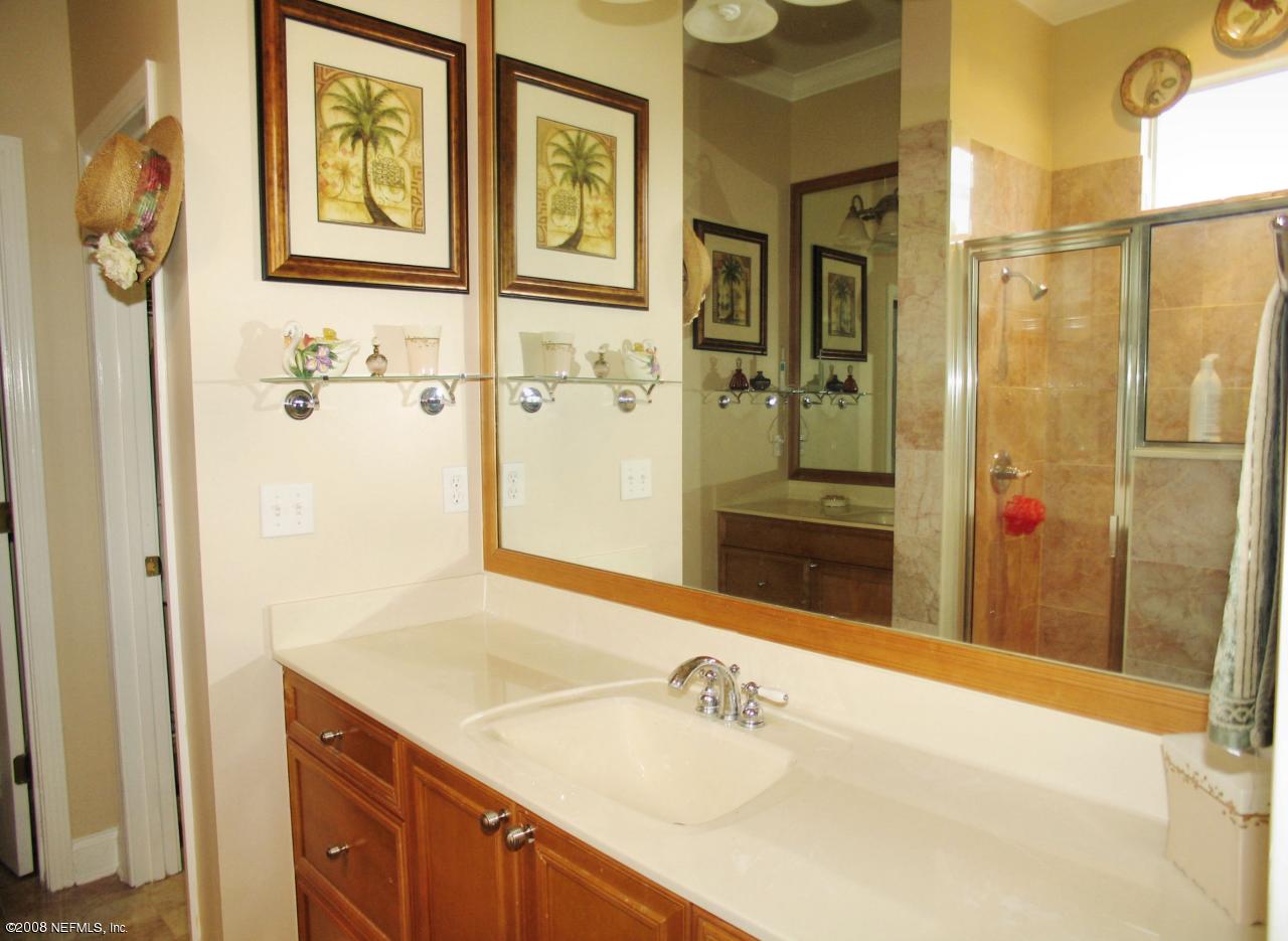 205 Edge Of Woods Road St. Augustine, FL 32092 - Photo 7 of 16 a bathroom with a sink and a mirror