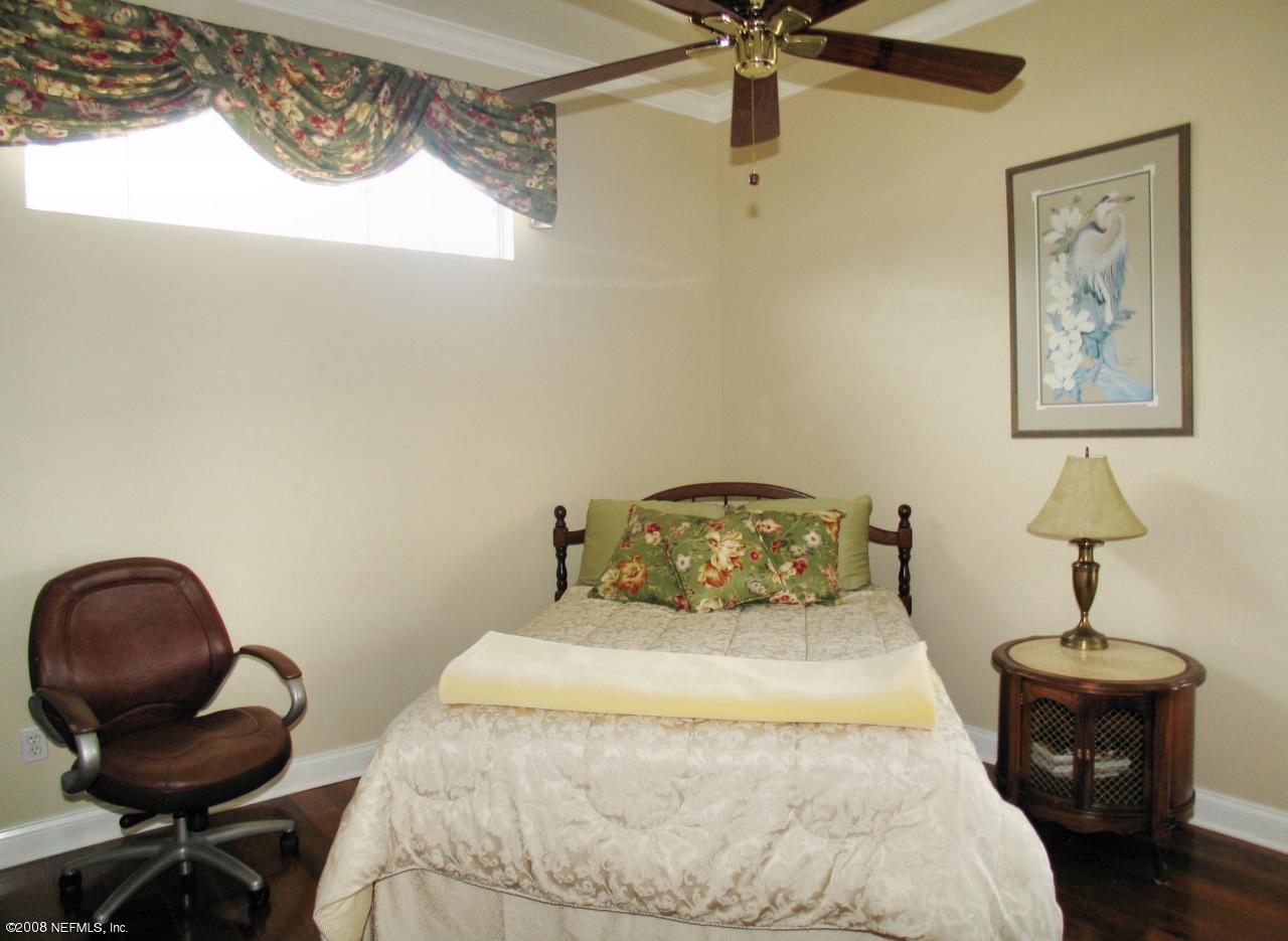 205 Edge Of Woods Road St. Augustine, FL 32092 - Photo 10 of 16 a bedroom with a bed and a chair