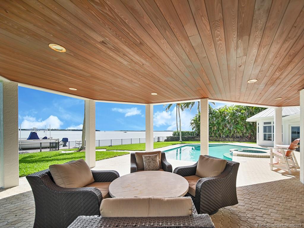 10 Island Road Stuart, FL 34996 - Photo 23 of 60 a balcony with furniture and a garden