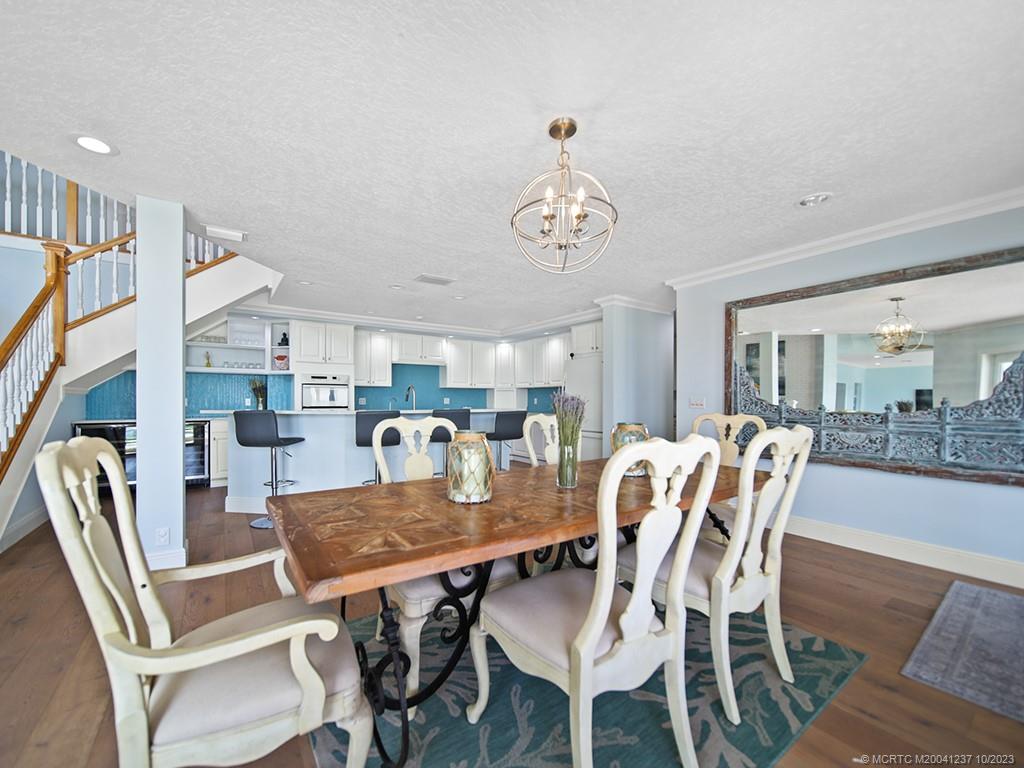 10 Island Road Stuart, FL 34996 - Photo 29 of 60 a dining room with furniture a rug and wooden floor