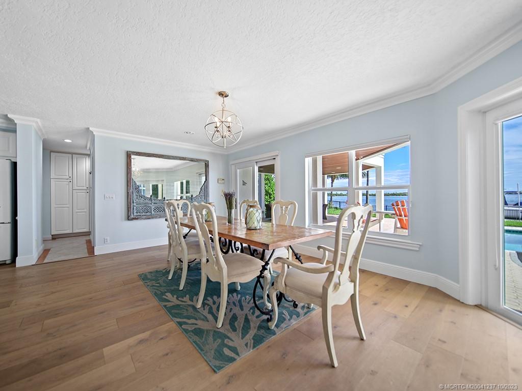 10 Island Road Stuart, FL 34996 - Photo 30 of 60 a view of a dining room with furniture window and wooden floor