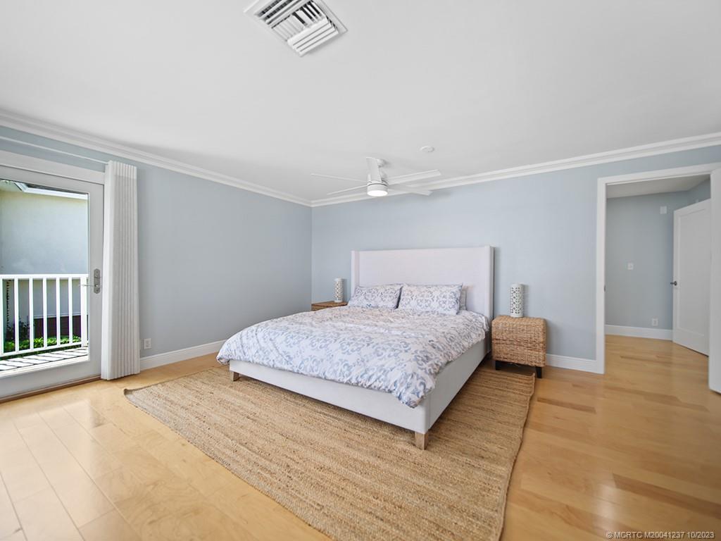 10 Island Road Stuart, FL 34996 - Photo 36 of 60 a bedroom with a bed and a window