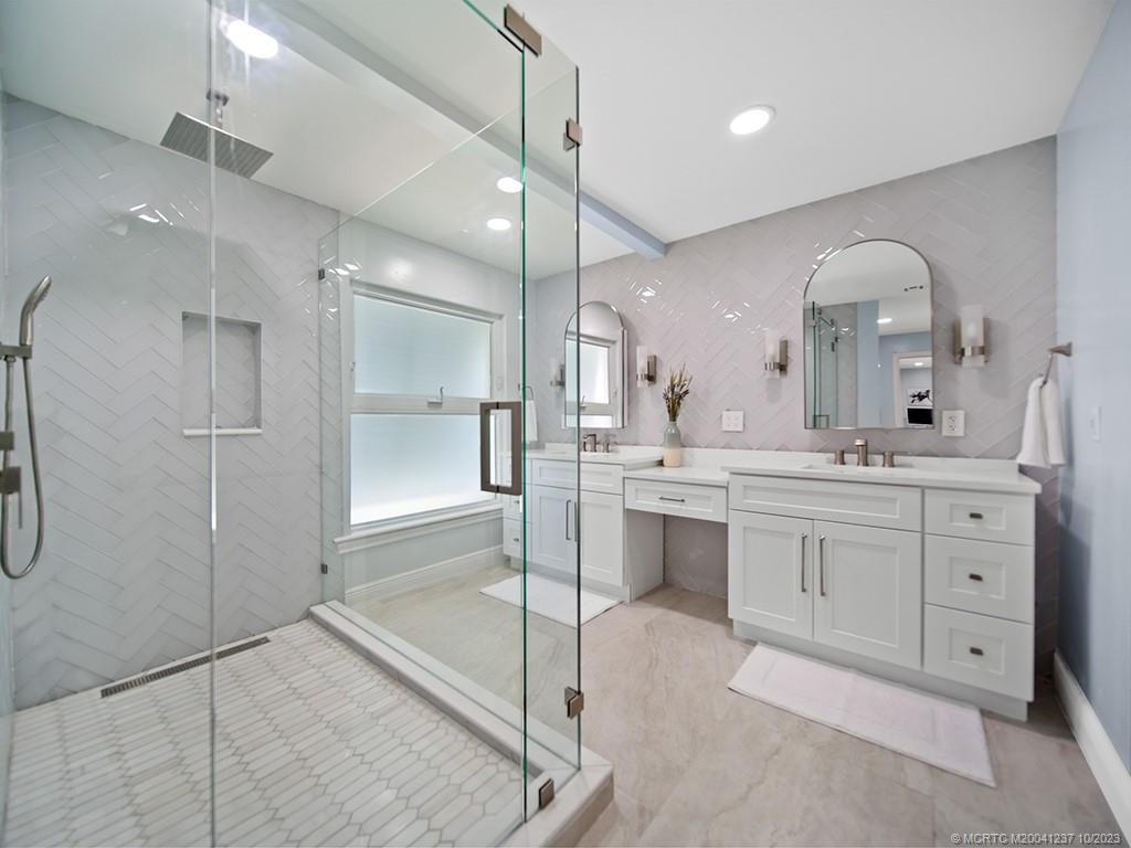 10 Island Road Stuart, FL 34996 - Photo 38 of 60 a bathroom with a double vanity sink mirror and shower
