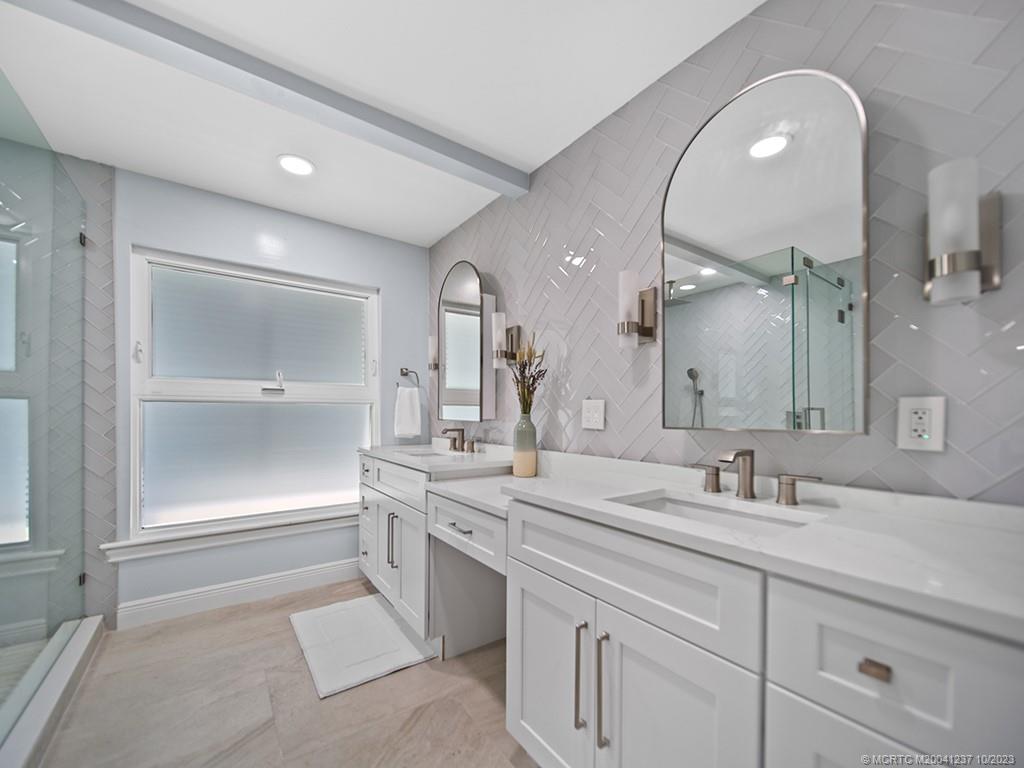 10 Island Road Stuart, FL 34996 - Photo 39 of 60 a bathroom with a sink and a mirror